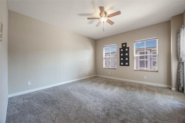 spare room featuring ceiling fan and carpet flooring