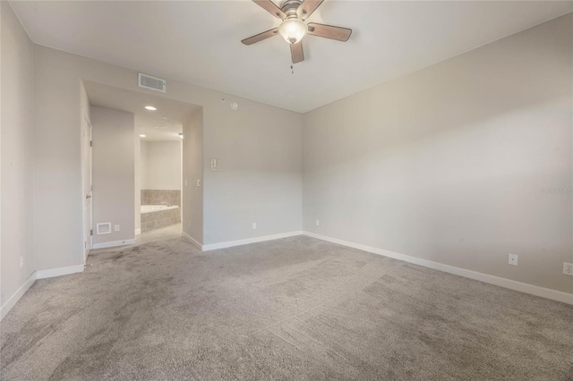 carpeted empty room featuring ceiling fan