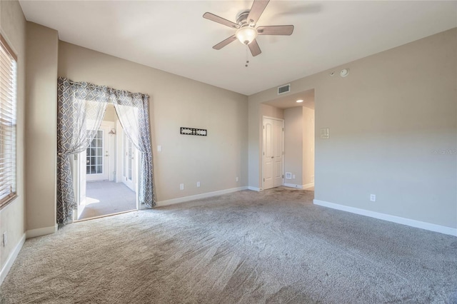 spare room with ceiling fan and light carpet