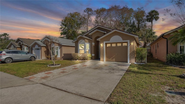 view of front of house with a garage and a lawn