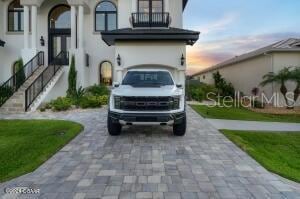 801 N Flagler Ave, Flagler Beach, FL 32136 - view of front facade featuring a garage and a lawn