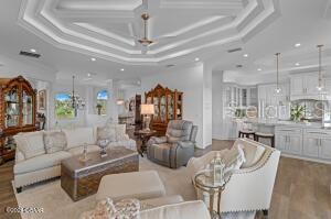 801 N Flagler Ave, Flagler Beach, FL 32136 - living room with a raised ceiling, ornamental molding, and light hardwood / wood-style flooring