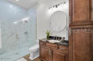 801 N Flagler Ave, Flagler Beach, FL 32136 - bathroom with vanity, toilet, and a shower with shower door