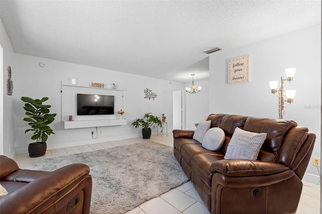 tiled living room featuring a notable chandelier and a textured ceiling