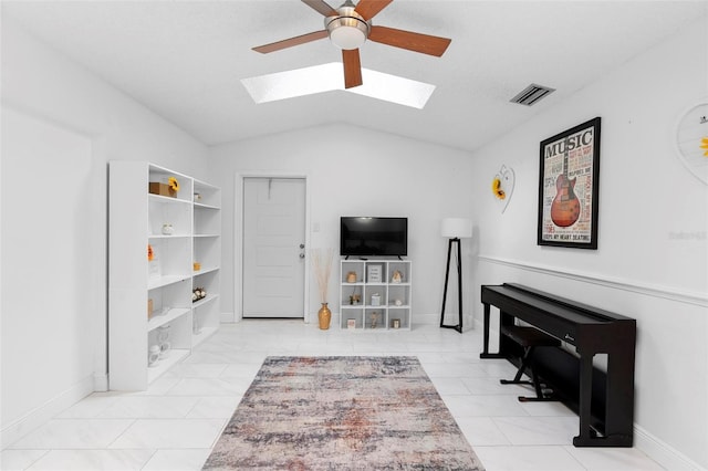 interior space featuring lofted ceiling with skylight and ceiling fan