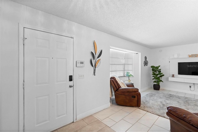 tiled foyer with a textured ceiling