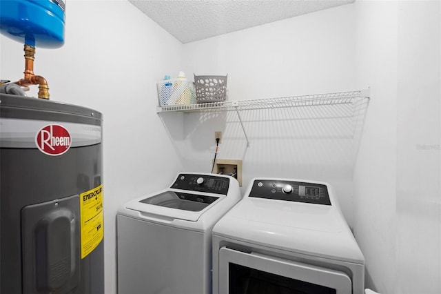 washroom with water heater, washing machine and clothes dryer, and a textured ceiling