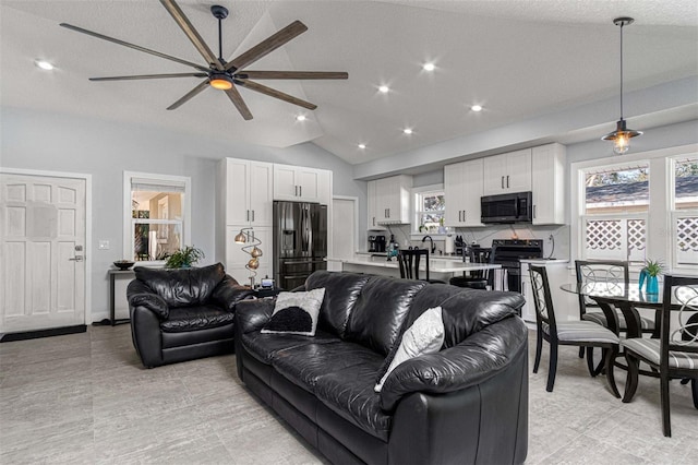 living room with lofted ceiling and ceiling fan