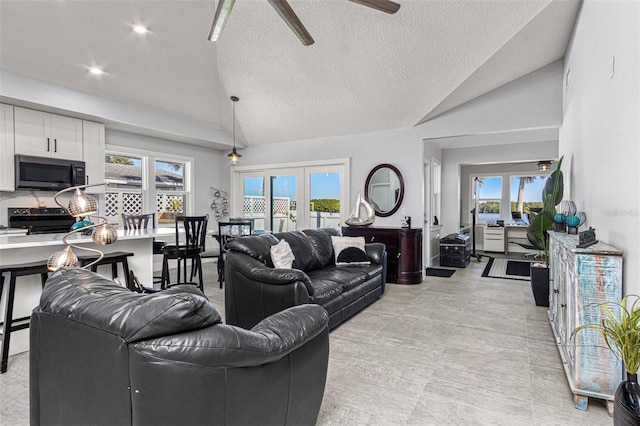 living room with high vaulted ceiling, a textured ceiling, ceiling fan, and french doors