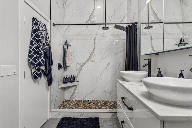 bathroom featuring vanity and tiled shower