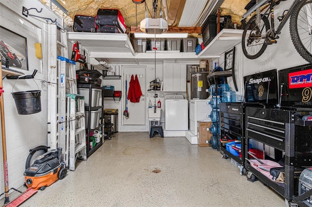 garage with a garage door opener, washer and clothes dryer, and water heater