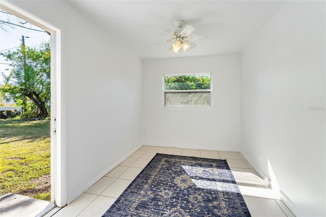 spare room featuring light tile patterned floors and ceiling fan