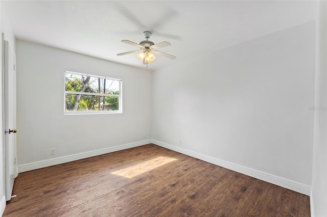 spare room with dark wood-type flooring and ceiling fan