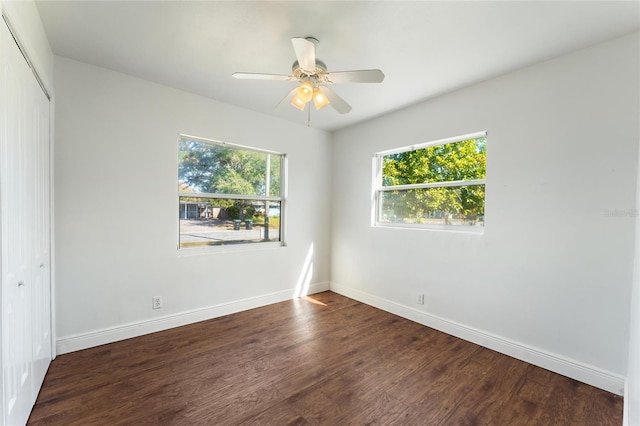 spare room with ceiling fan and dark hardwood / wood-style floors