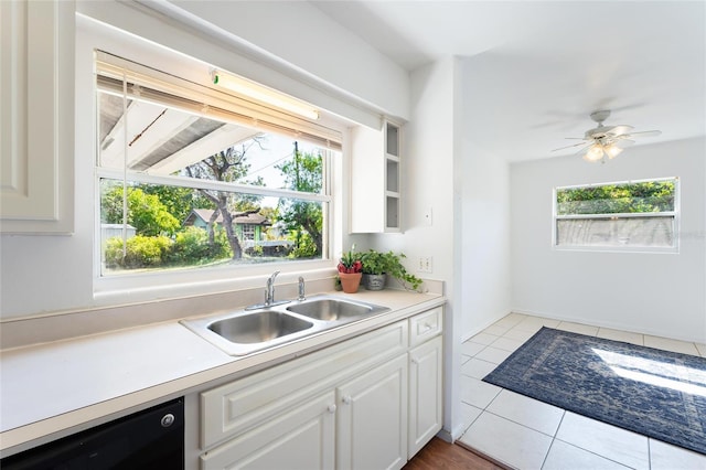 kitchen featuring black dishwasher, sink, white cabinets, and ceiling fan