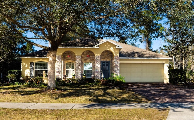 view of front facade with a garage and a front lawn