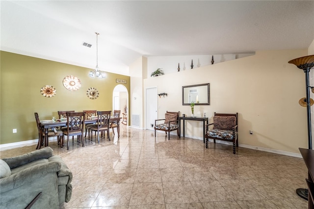 dining area with high vaulted ceiling and a chandelier