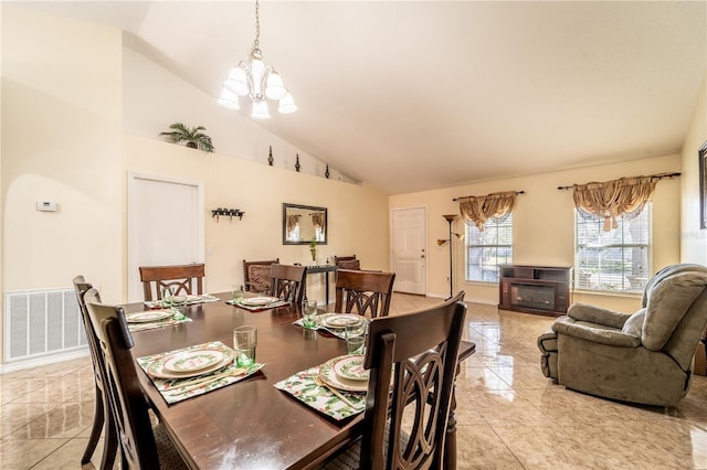 dining space with a chandelier and high vaulted ceiling