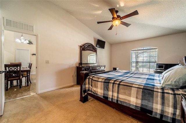 bedroom with ceiling fan, lofted ceiling, carpet floors, and a textured ceiling