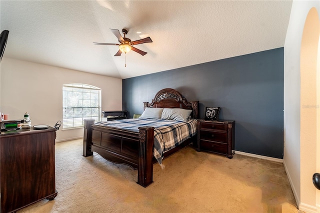 carpeted bedroom featuring ceiling fan, lofted ceiling, and a textured ceiling