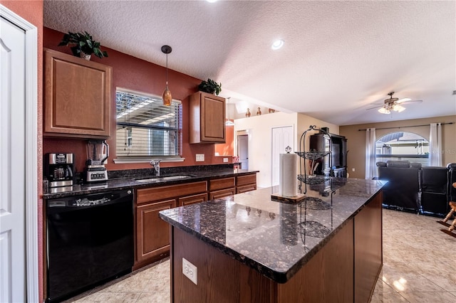 kitchen featuring sink, dishwasher, a wealth of natural light, decorative light fixtures, and dark stone counters