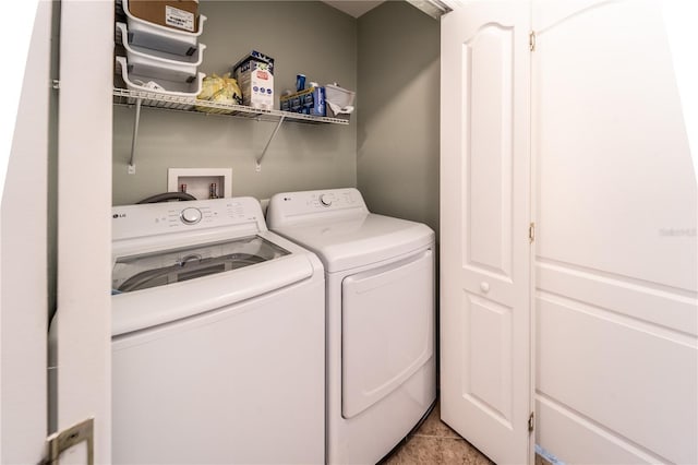 clothes washing area featuring light tile patterned floors and independent washer and dryer