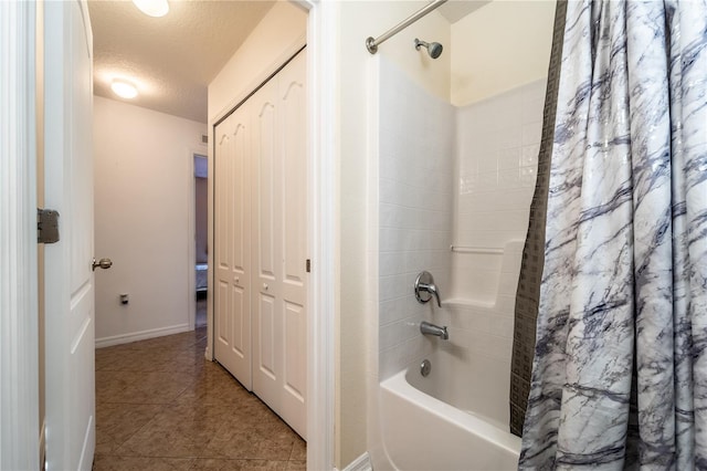 bathroom featuring shower / tub combo with curtain, tile patterned floors, and a textured ceiling