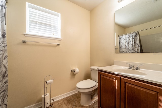 bathroom featuring a shower with curtain, vanity, tile patterned floors, and toilet