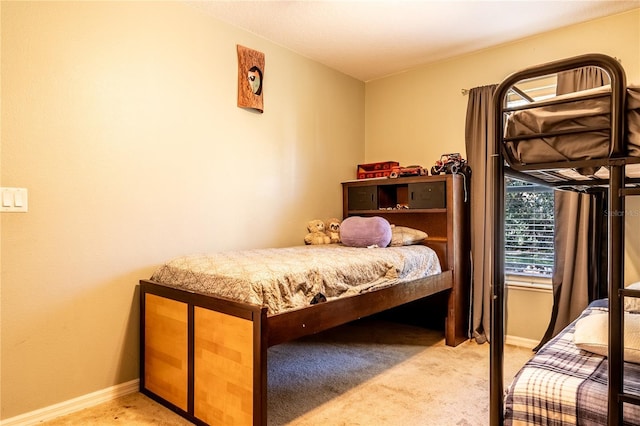 bedroom featuring light carpet