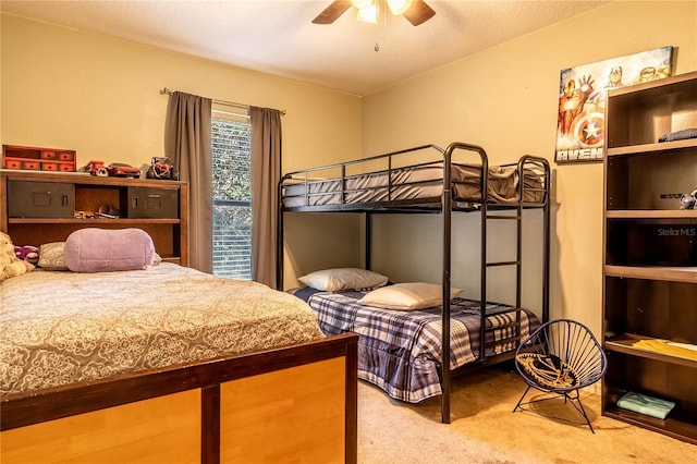 bedroom featuring carpet floors, a textured ceiling, and ceiling fan