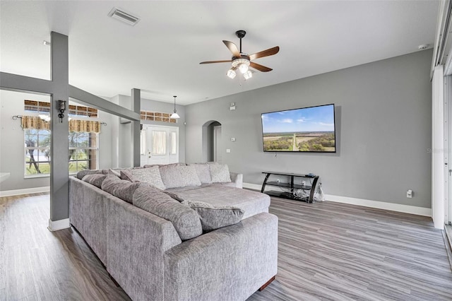 living room featuring wood-type flooring and ceiling fan