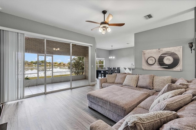 living room with ceiling fan and light hardwood / wood-style floors