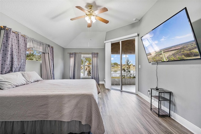 bedroom with vaulted ceiling, wood-type flooring, access to outside, ceiling fan, and a textured ceiling