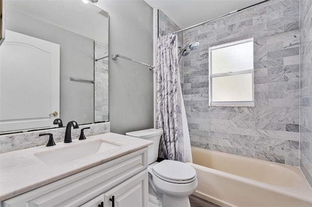 full bathroom featuring vanity, shower / tub combo with curtain, and toilet