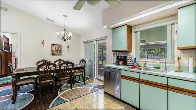 kitchen with vaulted ceiling, decorative light fixtures, dishwasher, sink, and plenty of natural light