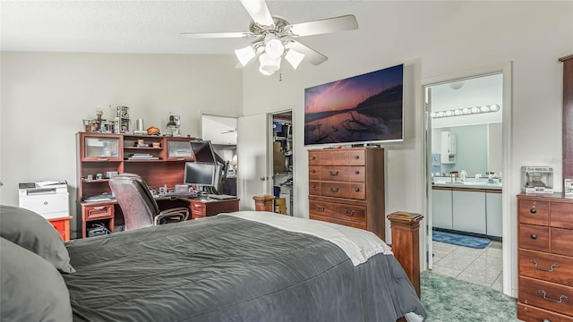 tiled bedroom featuring ensuite bath, a textured ceiling, and ceiling fan