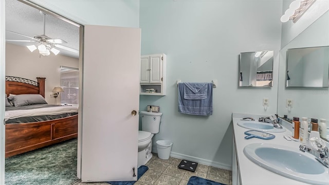 bathroom with vanity, a textured ceiling, ceiling fan, and toilet