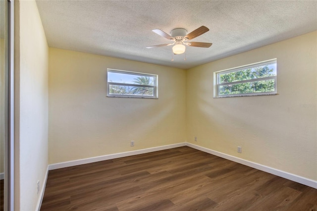 unfurnished room featuring ceiling fan, dark hardwood / wood-style floors, and a textured ceiling