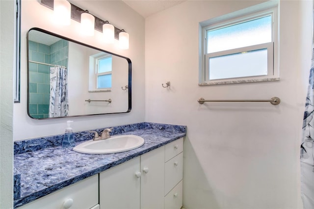 bathroom with vanity and curtained shower