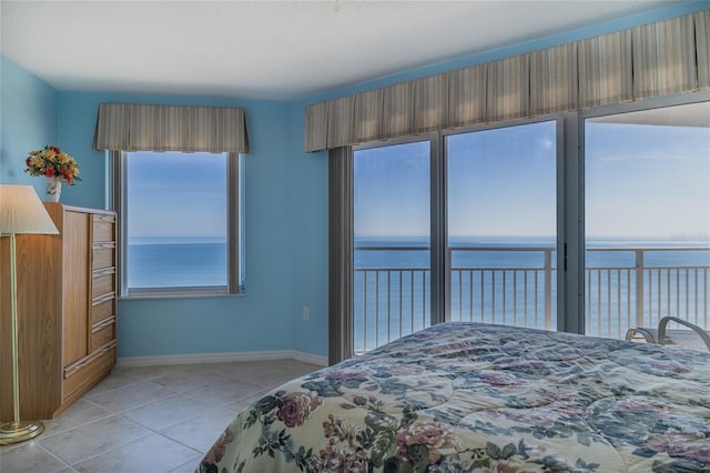 tiled bedroom with a water view