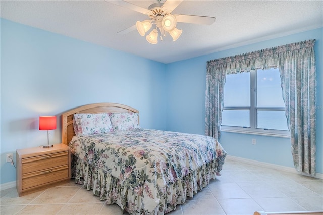 tiled bedroom with ceiling fan, a textured ceiling, and a water view