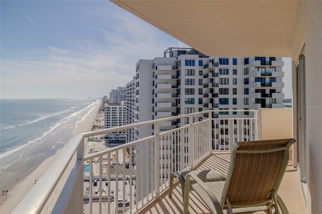 balcony with a water view and a beach view