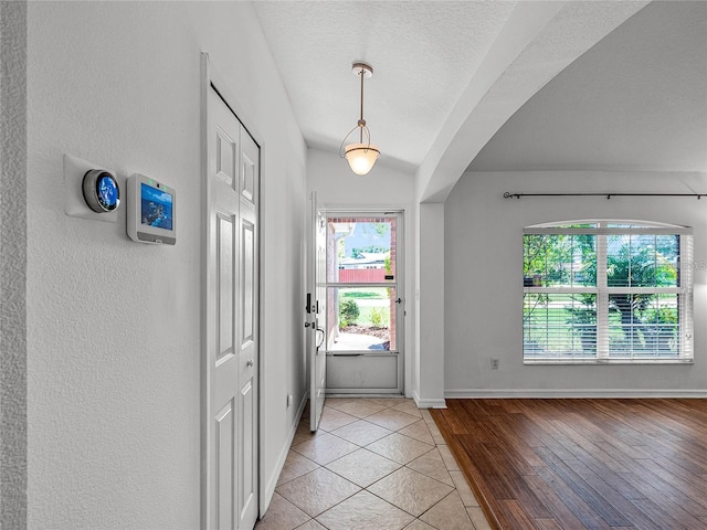 entryway featuring a textured ceiling and light wood-type flooring