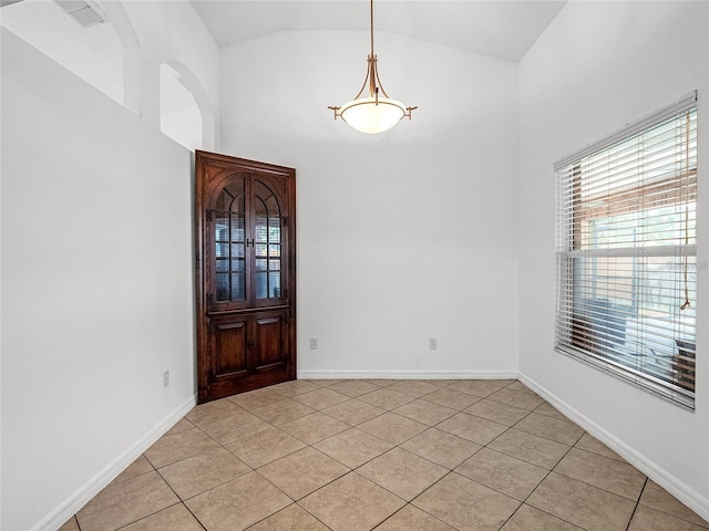 tiled foyer with vaulted ceiling