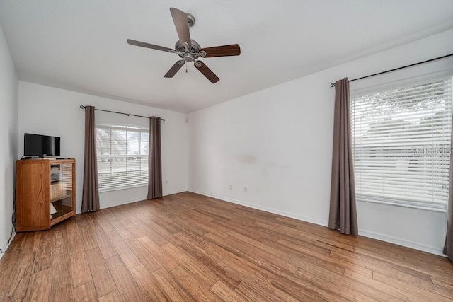 unfurnished room with ceiling fan and light wood-type flooring