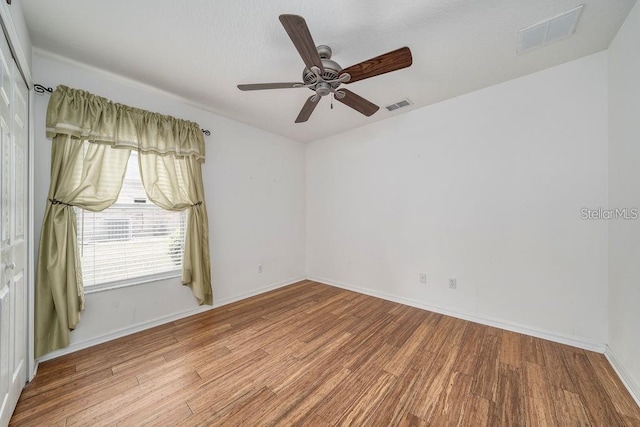 spare room with ceiling fan and light hardwood / wood-style floors