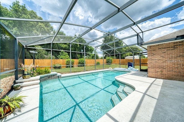 view of swimming pool featuring a patio area and glass enclosure