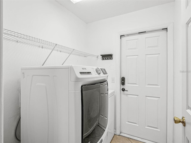 washroom with light tile patterned flooring and independent washer and dryer