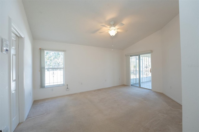 carpeted empty room featuring vaulted ceiling and ceiling fan