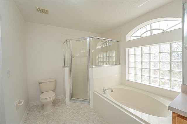 full bathroom with plenty of natural light, independent shower and bath, vanity, and a textured ceiling